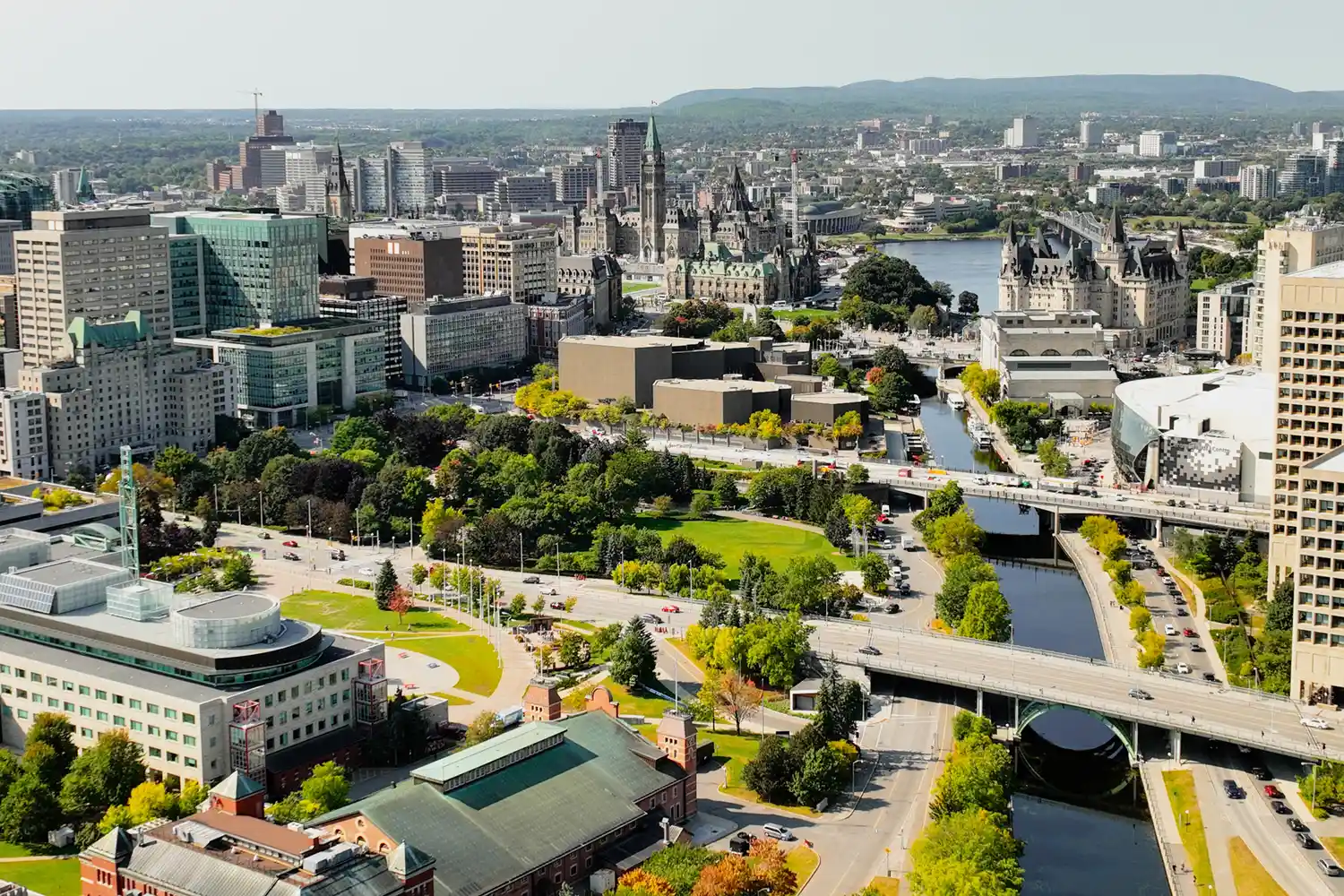 Aerial view of Ottawa city streets and historic buildings showing the proximity of the river and parks.