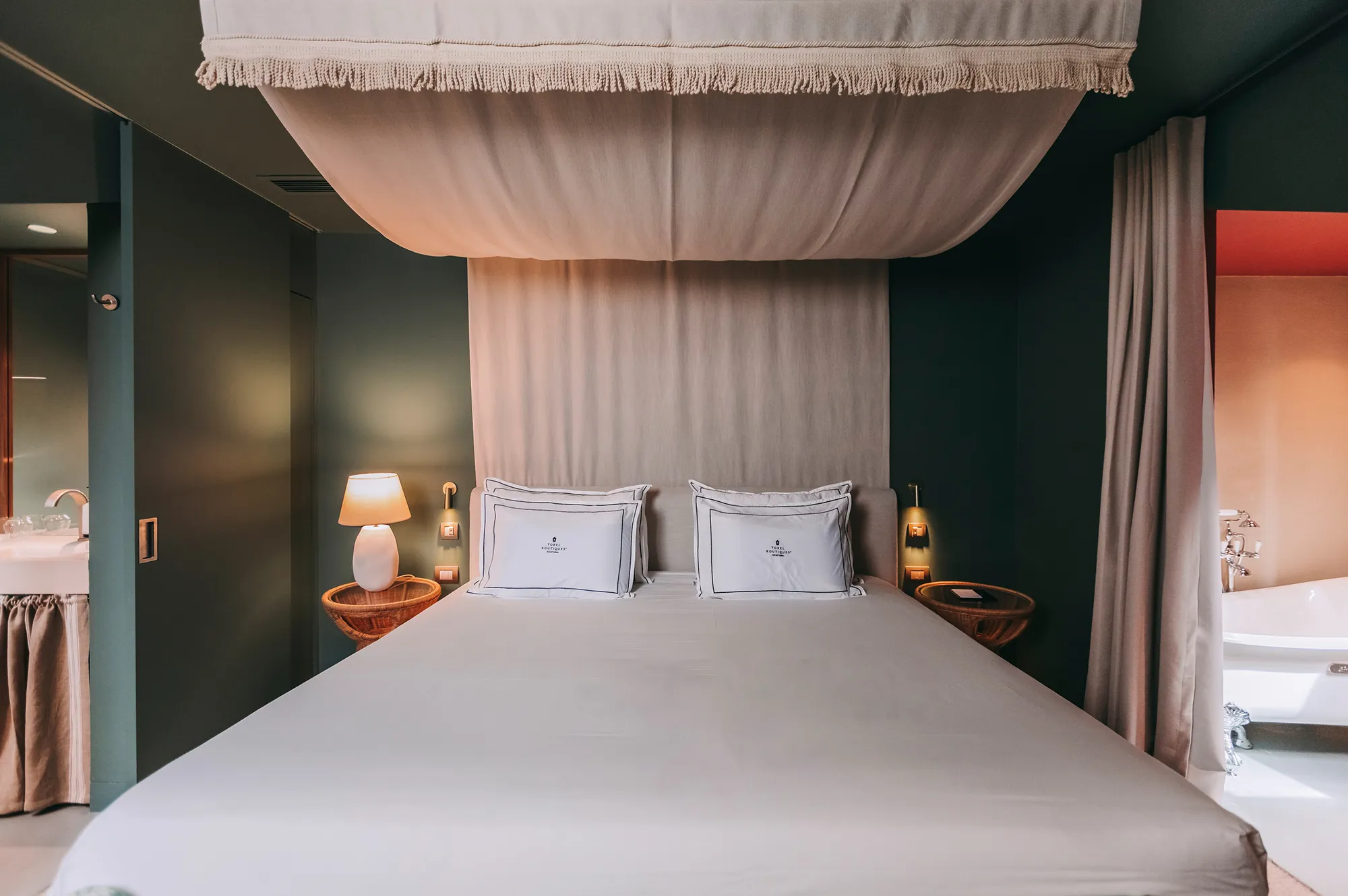 Boutique hotel bedroom at Torel Terra Brava featuring a stylish canopy bed and natural textures.