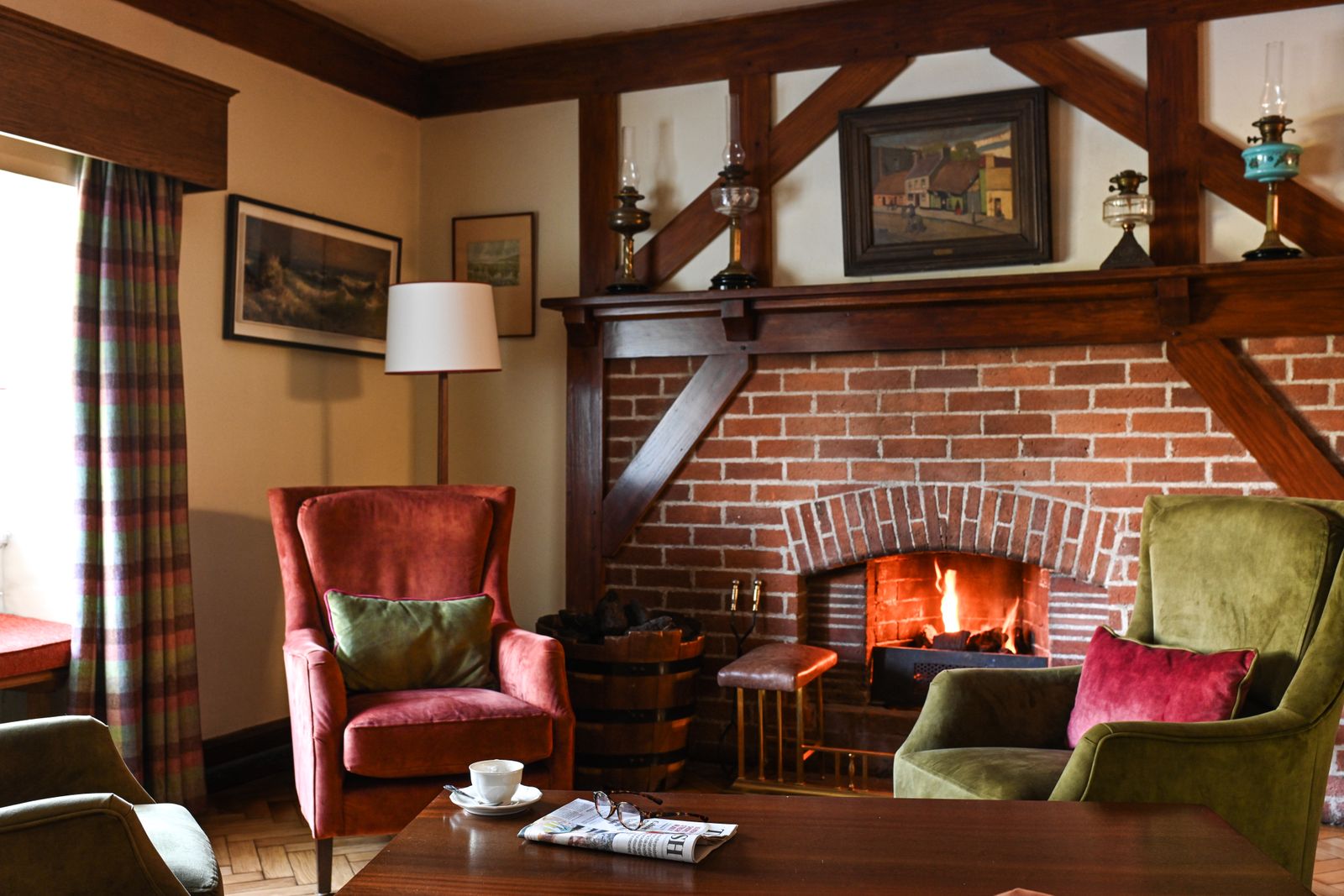 A warm, luxuriously designed living room with a stone fireplace and elegant furniture.