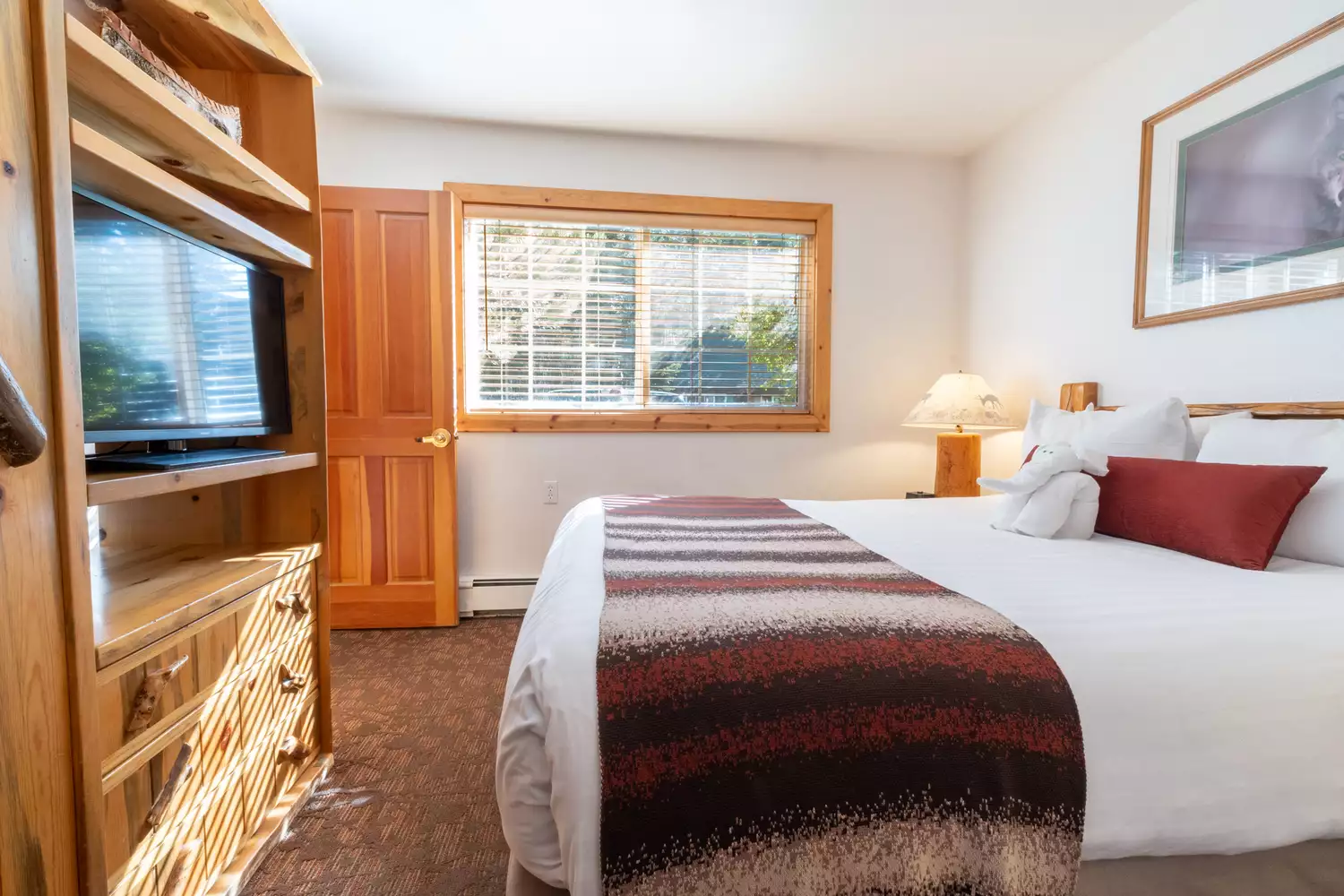 Interior of a one-bedroom guest room at Red Wolf Lakeside Lodge with a cozy design.