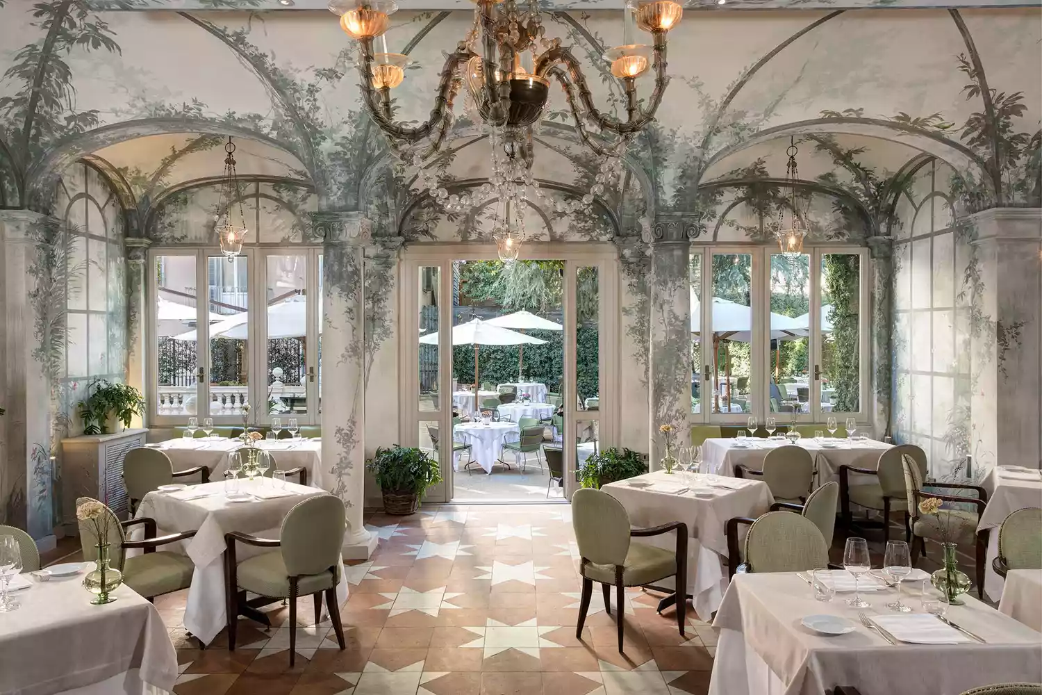 Lush greenery and outdoor tables at Le Jardin de Russie within the secret garden.