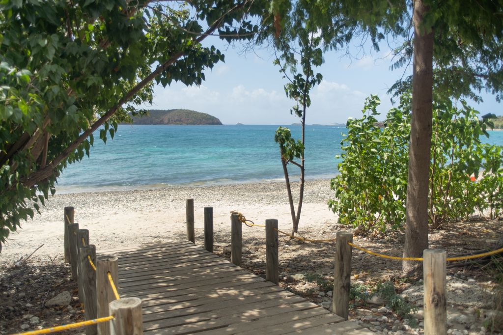 The clear turquoise waters and rocky shoreline of Tamarindo Beach in Culebra.