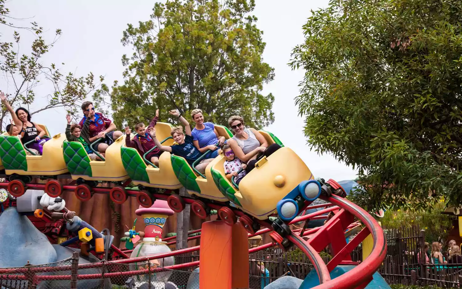 Guests walking near the Storybook Land Canal Boats and the Matterhorn Bobsleds.